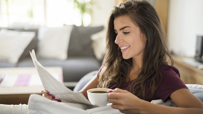 Een afbeelding van een jonge vrouw die koffie drinkt.