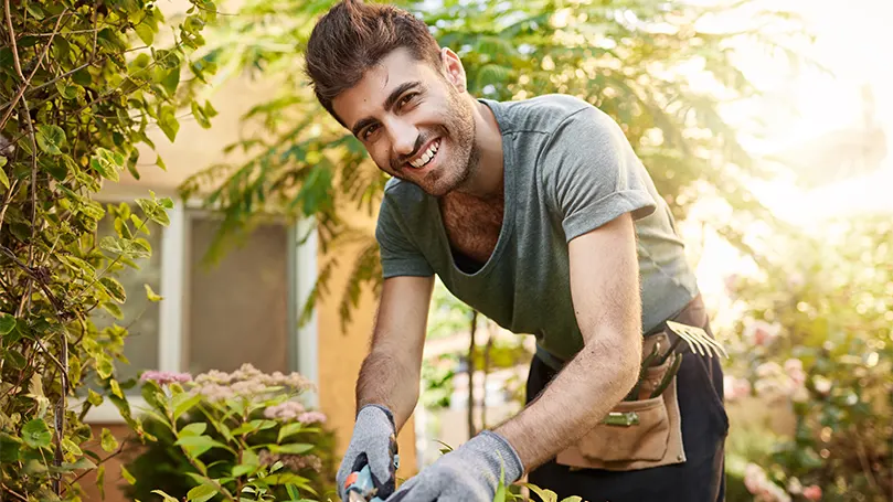 Een beeld van een man die in de tuin werkt bij daglicht.