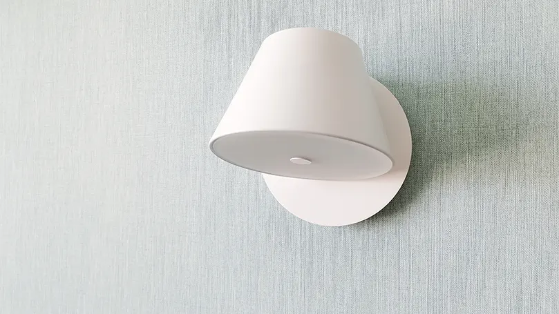 Een afbeelding van een witte wandlamp.